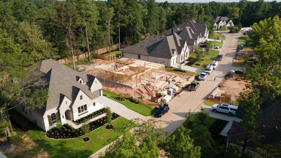 Home construction continues in The Woodlands Hill residential community, Thursday, Aug. 5, 2021, in Willis.