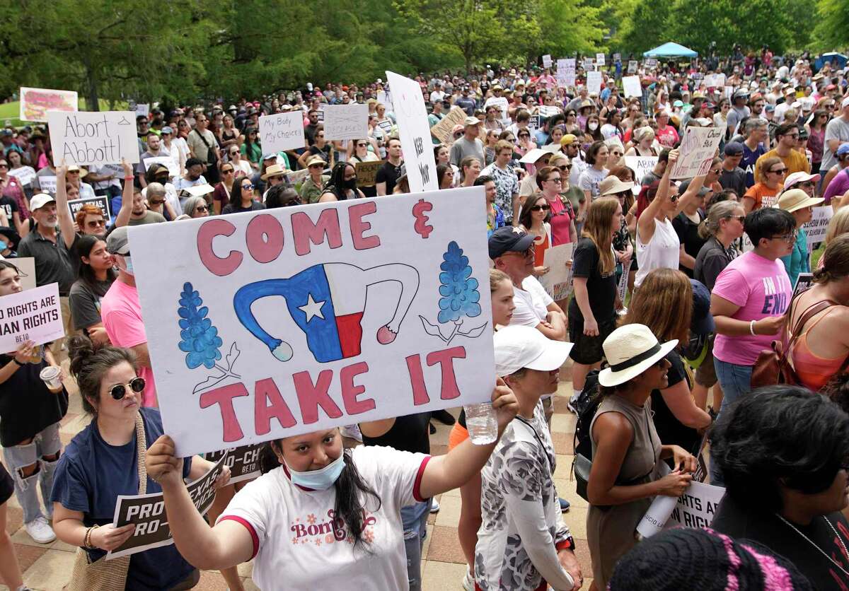 A woman in the crowd with a “Come and Take It” sign during an abortion rights rally organized by Beto O’Rourke at Discovery Green on Saturday, May 7, 2022 in Houston.
