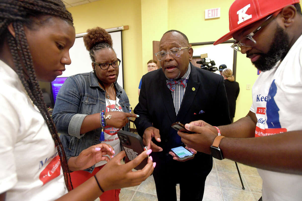 Incumbent Port Arthur Mayor Thurman Bartie looks over incoming results with (from left) granddaughter Tierra Bartie, daughter Thurvonni Bartie and Paul Hypolite, Jr., during an election night watch party Saturday. Photo made Saturday, May 7, 2022. Kim Brent/The Enterprise