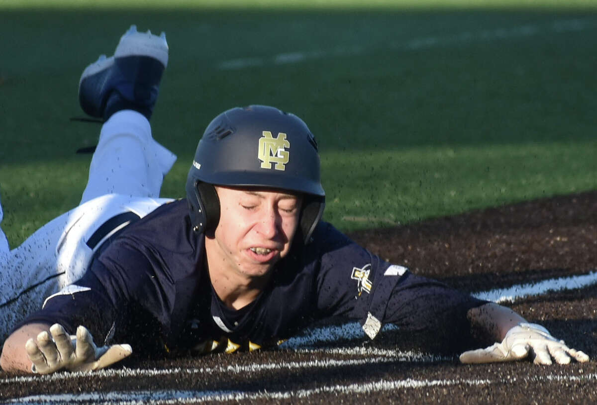 Father McGivney's Mason Holmes slides safely across home plate against Mater Dei on Saturday at Gordon Moore Park in Alton.