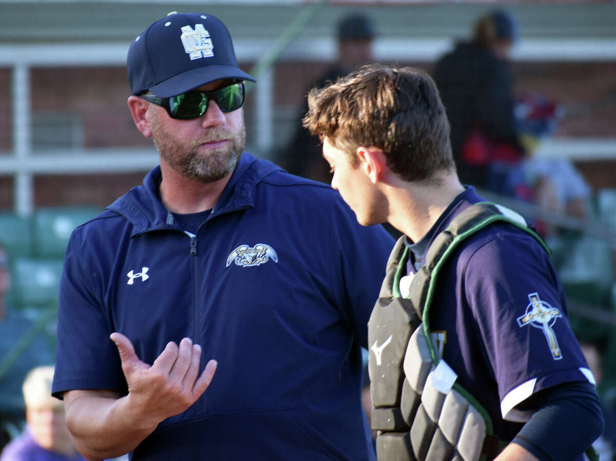 Father McGivney coach Chris Erwin talks to Sam Chouinard in between innings during a game against Mater Dei earlier this season at Gordon Moore Park in Alton.