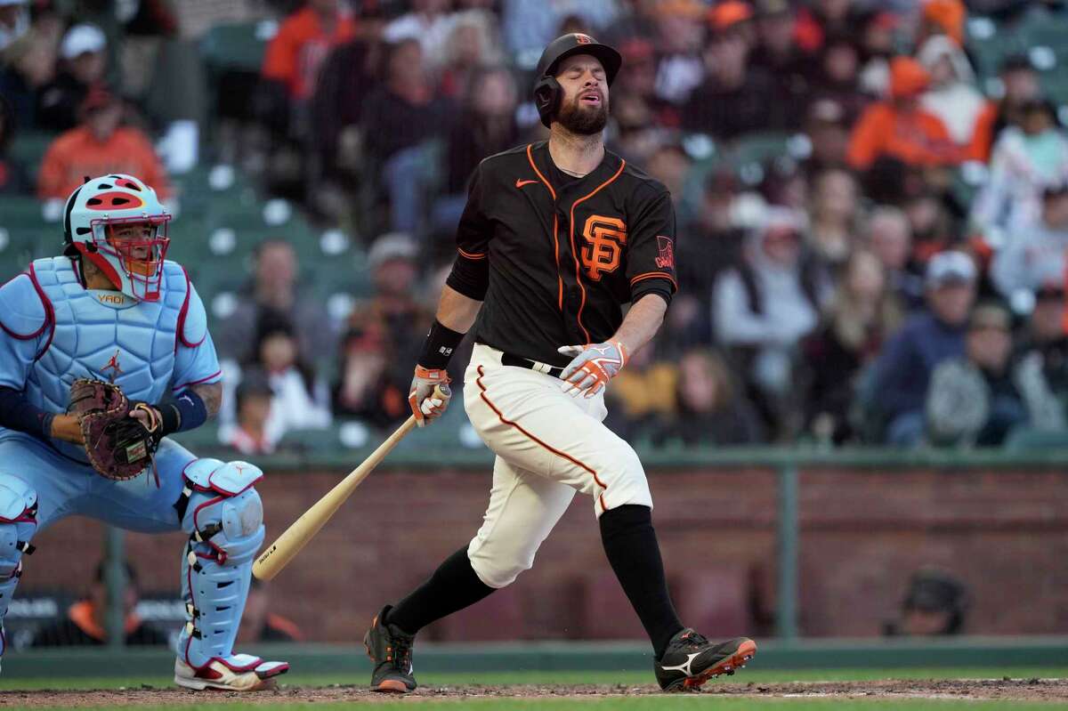 San Francisco Giants' Brandon Belt reacts after swing at a pitch during the eighth inning against the St. Louis Cardinals in a baseball game Saturday, May 7, 2022, in San Francisco. Belt left the game after the swing. (AP Photo/Tony Avelar)