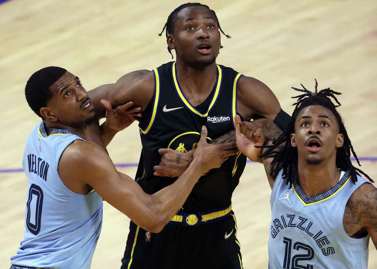 Golden State Warriors’ Jonathan Kuminga vies for rebound position against Memphis Grizzlies’ De’Anthony Melton and Ja Morant during Game 3 of NBA Western Conference Semifinals in San Francisco, Calif., on Saturday, May 7, 2022.