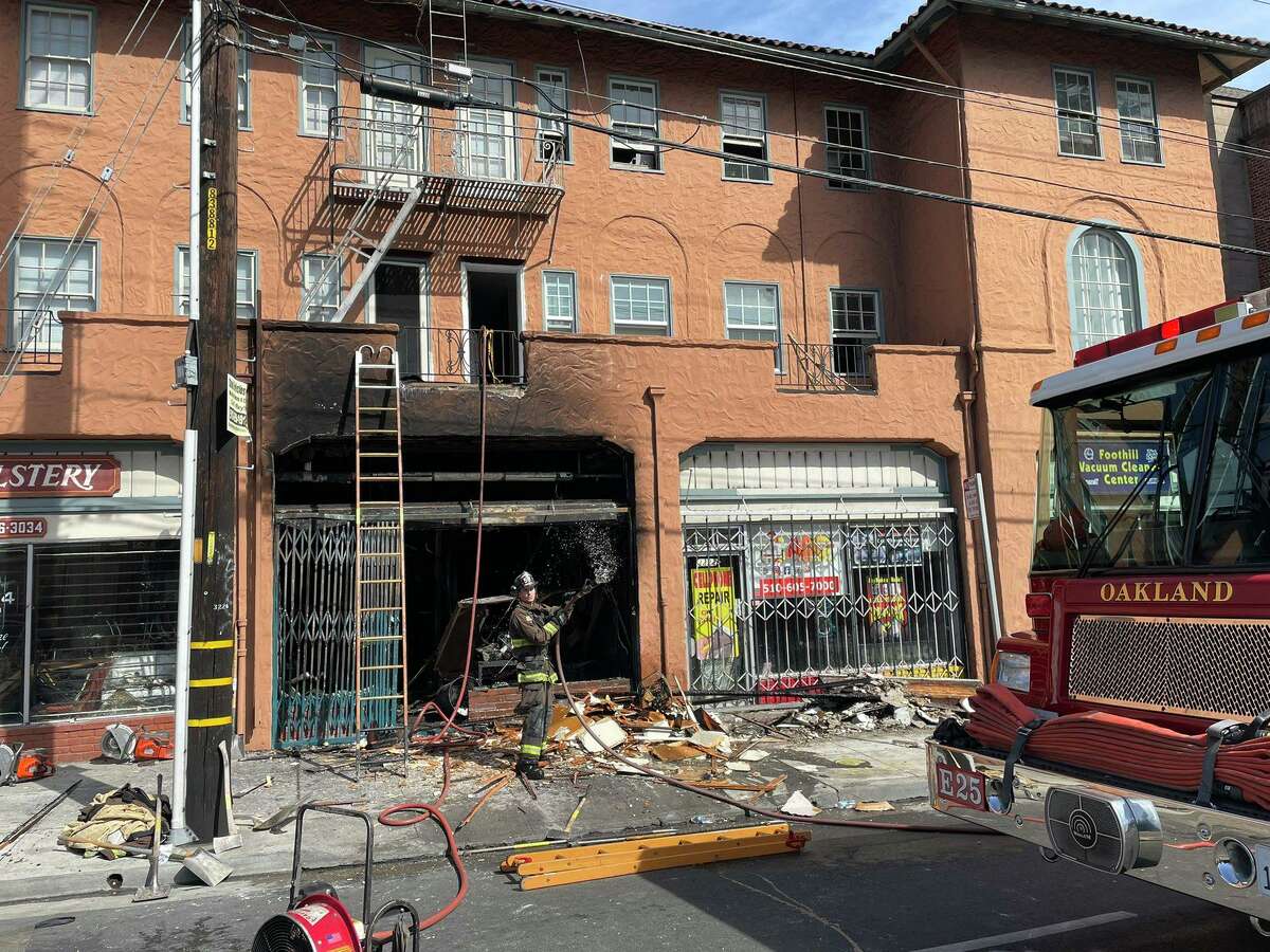 A fire at a mixed-use building in Oakland's Dimond District displaced four households and burned through at least four businesses, according to the city's Fire Department.