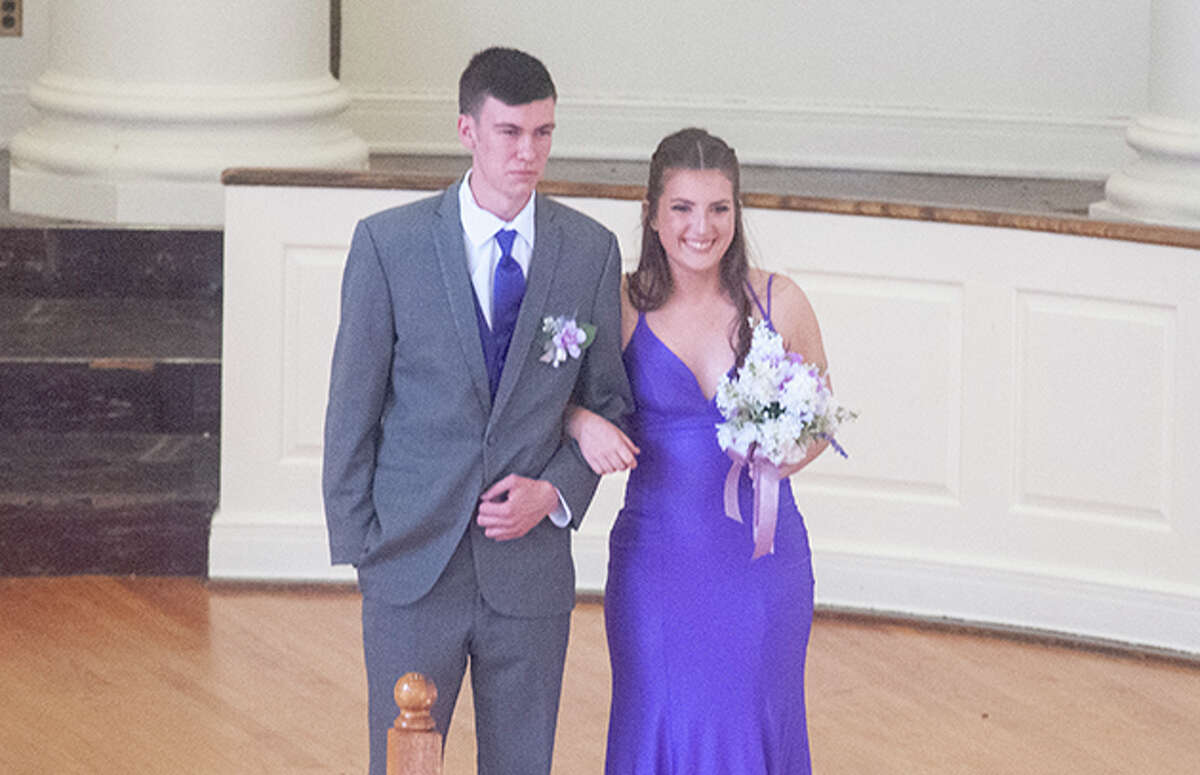 Routt Catholic High School students march Saturday before attending prom. 