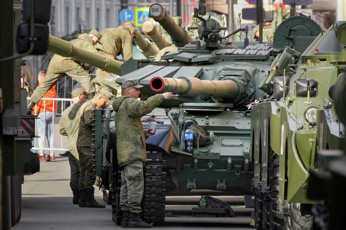 Russian soldiers tint their T-72 tanks on the eve of the Victory Day military parade. Oil markets and the world will watch if President Vladimir Putin uses the annual celebration to make pronouncements about the direction of the war in Ukraine.