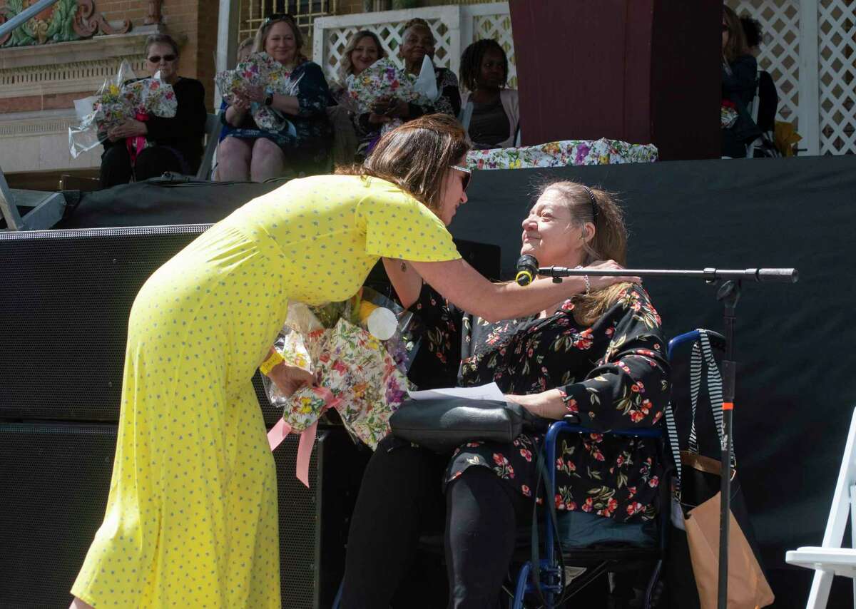 Capital Region Best Mom nominee, Melinda Person, left, gives a hug to her mom, Elaine Person, on the final day of the Tulip Festival on Sunday, May 8, 2022, in Albany, N.Y. Elaine Person nominated her daughter for Capital Region Best Mom. Elaine Person was crowned best mom back in 2006. This year's Capital Region Best Mom was awarded to Patricia Joyce-O'Toole. (Paul Buckowski/Times Union)