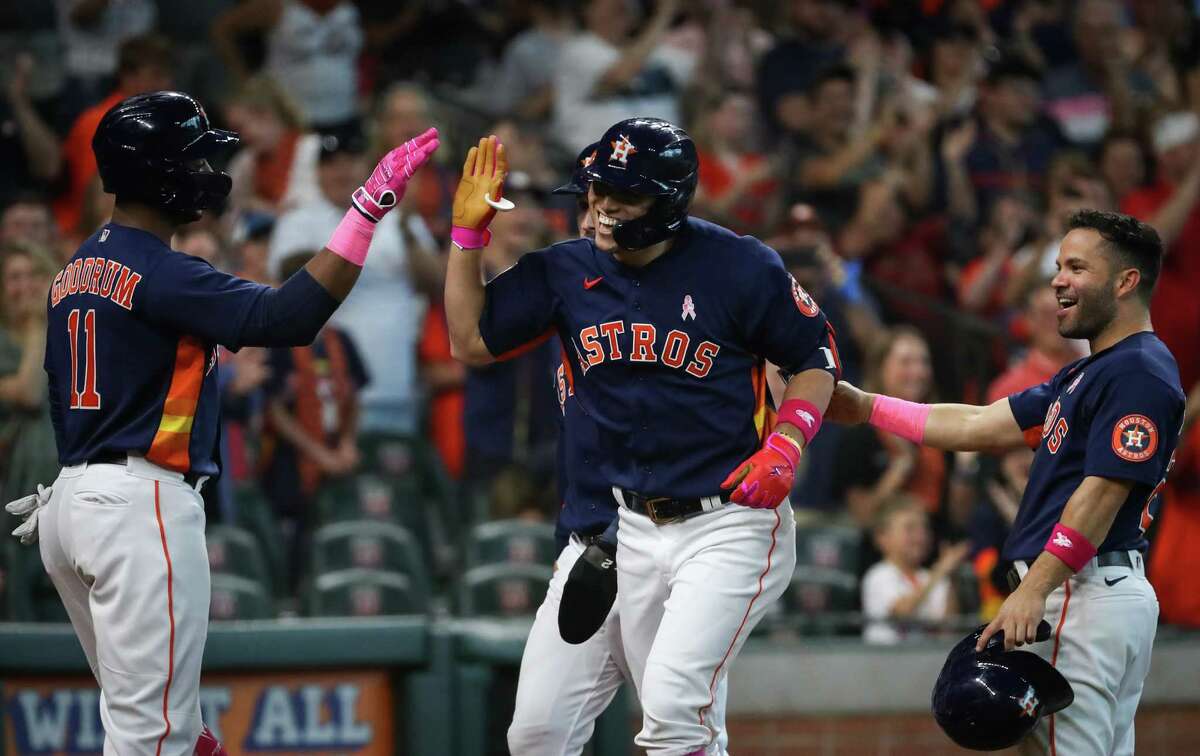 Houston Astros shortstop Aledmys Diaz (16) celebrates with first baseman Niko Goodrum (11) and second baseman Jose Altuve (27) after hitting a grand slam during the third inning of an MLB game Sunday, May 8, 2022, at Minute Maid Park in Houston.
