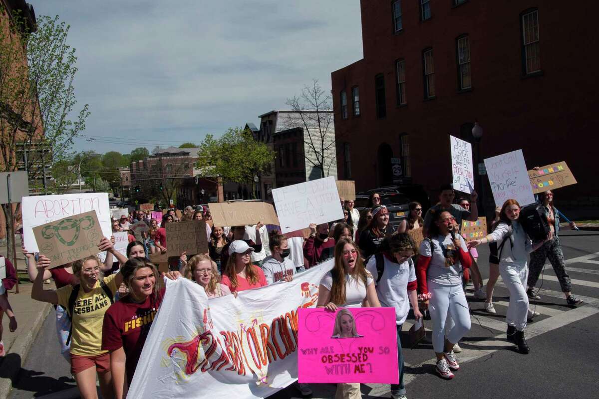 Protesters march up Lake Ave. towards Broadway during the Our Bodies Our Choice protest on Sunday, May 8, 2022, in Saratoga Springs, N.Y. The march was organized by high school students from Saratoga Springs High School and Argyle High School. About 200 people took part in the march which began in Congress Park. Protesters marched through the streets working their way up to Broadway where they headed south on Broadway, temporarily blocking each intersection to listen to someone speak. Saratoga Springs Police blocked traffic on several roads to keep vehicles off of Broadway. (Paul Buckowski/Times Union)