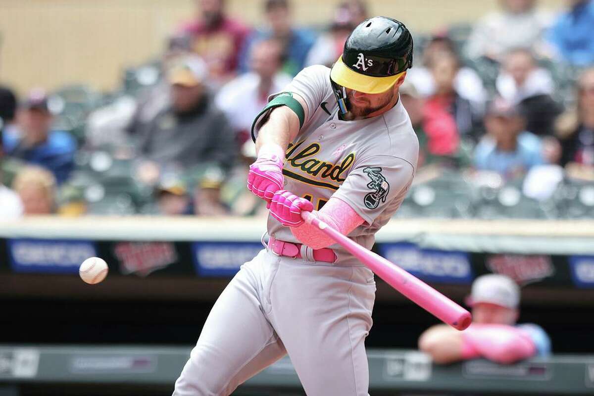 Oakland Athletics left fielder Seth Brown (15) hits a single during the first inning of a baseball game against the Oakland Athletics, Sunday, May 8, 2022, in Minneapolis. (AP Photo/Stacy Bengs)