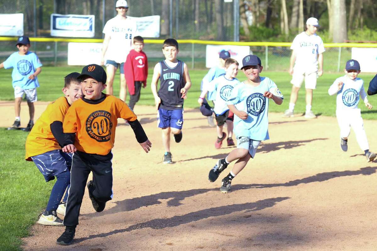 Wilton Little League players race around the bases.