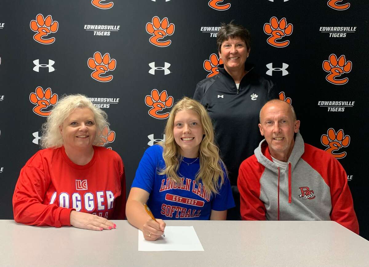 Edwardsville High School senior Charlotte Hayes, seated center, will play college softball for Lincoln Land. She is joined by her family and EHS coach Lori Blade.