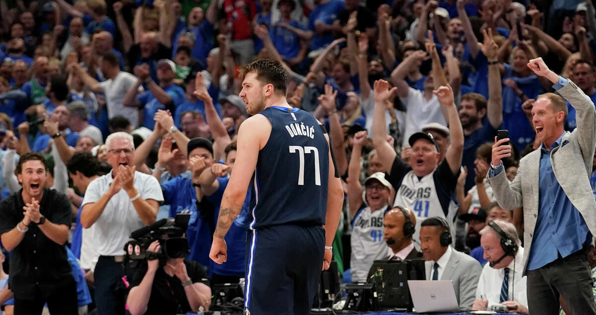 Dallas Mavericks guard Luka Doncic (77) and fans celebrate after a basket in the second half of Game 4 of an NBA basketball second-round playoff series against the Phoenix Suns, Sunday, May 8, 2022, in Dallas. (AP Photo/Tony Gutierrez)