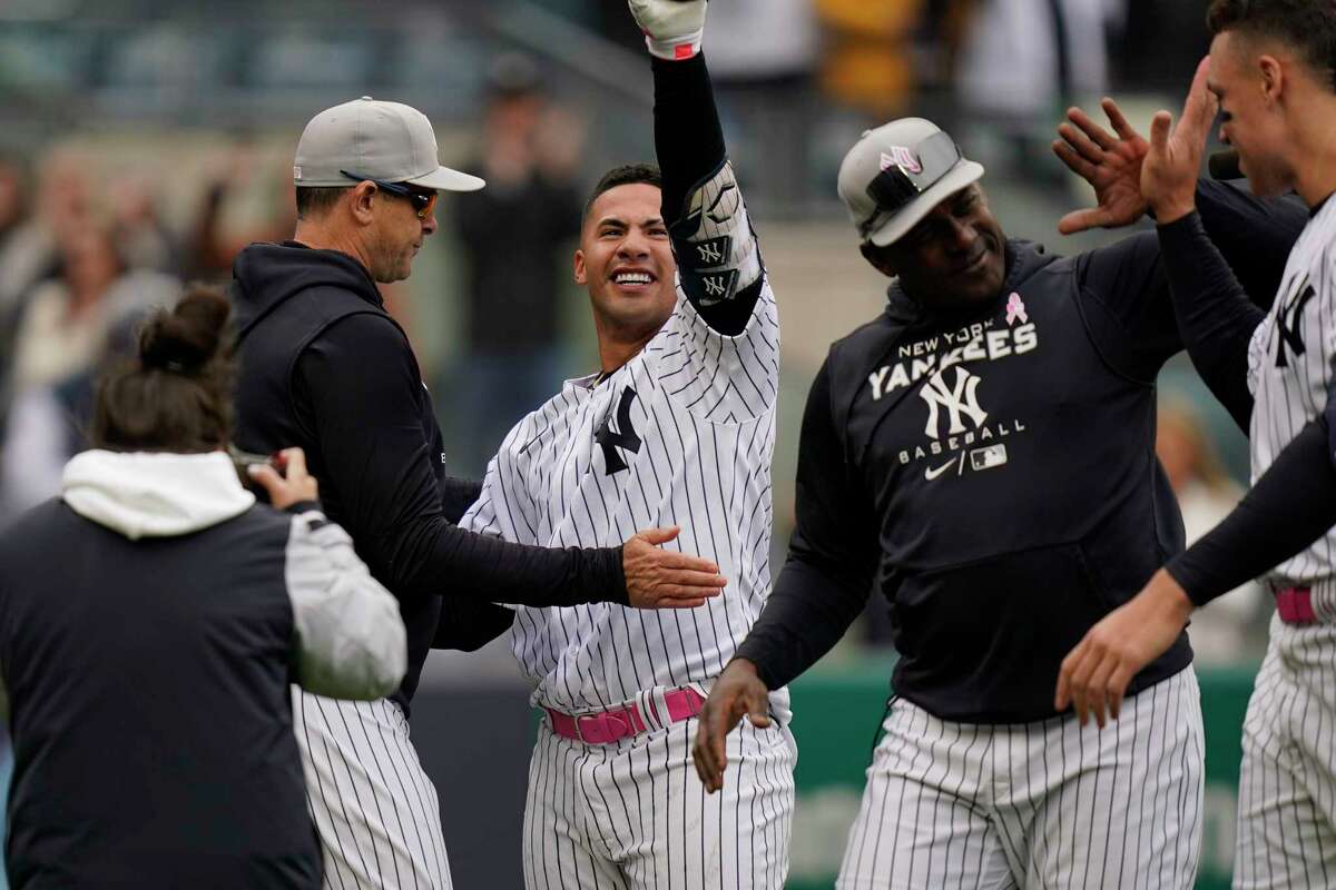 New York Yankees' Gleyber Torres celebrates with teammates after hitting a walk-off home run during the ninth inning of the first game of a baseball double-header against the Texas Rangers at Yankee Stadium, Sunday, May 8, 2022, in New York. The Yankees defeated the Rangers 2-1. (AP Photo/Seth Wenig)