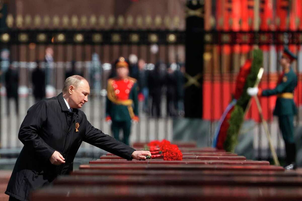 Russian President Vladimir Putin attends a wreath-laying ceremony at the Tomb of the Unknown Soldier after the military parade marking the 77th anniversary of the end of World War II in Moscow, Russia, Monday, May 9, 2022. (Anton Novoderezhkin, Sputnik, Kremlin Pool Photo via AP)