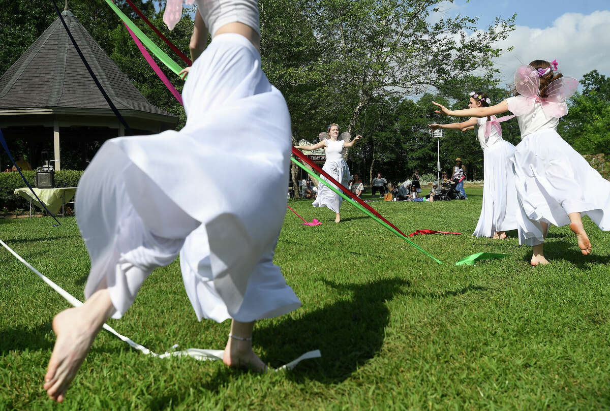 Dancers wrap the maypole in traditional fashion during the annual Maypole Festival in Tyrrell Park Saturday. Photo made Saturday, May 7, 2022. Kim Brent/The Enterprise