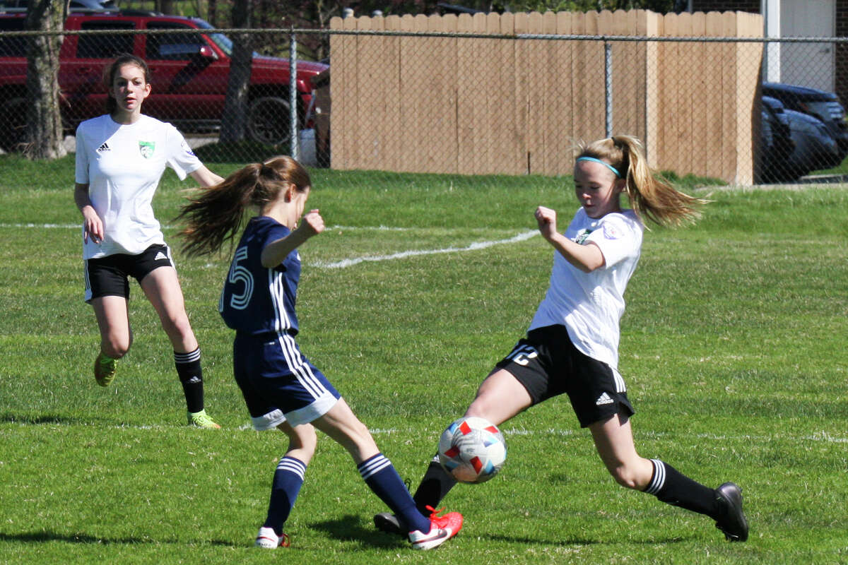 Midland Fusion's Kaitlin Sharp fights for possession while playing in the 39th annual Midland Invitational Tournament Saturday, May 9, 2022 at the Midland Soccer Club.