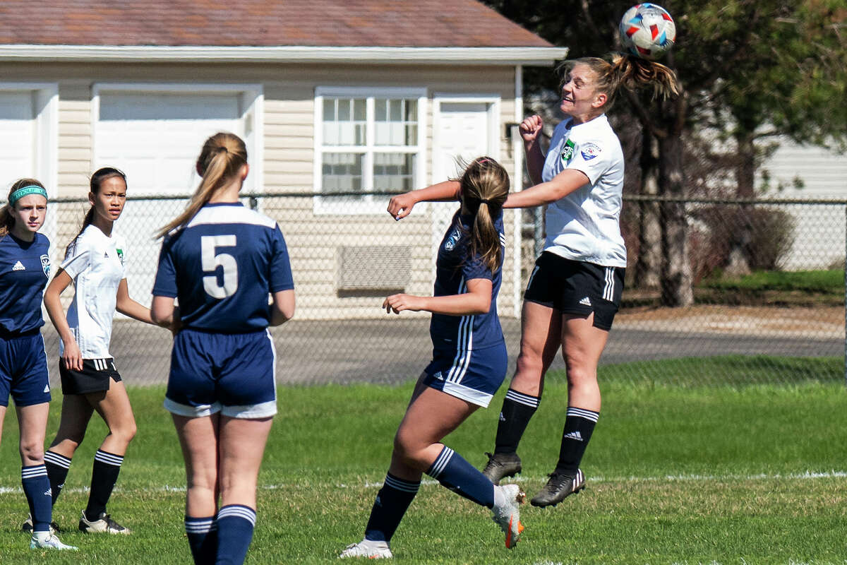 Midland Fusion's Audrey Kundinger jumps up for a header while playing in the 39th annual Midland Invitational Tournament Saturday, May 9, 2022 at the Midland Soccer Club.