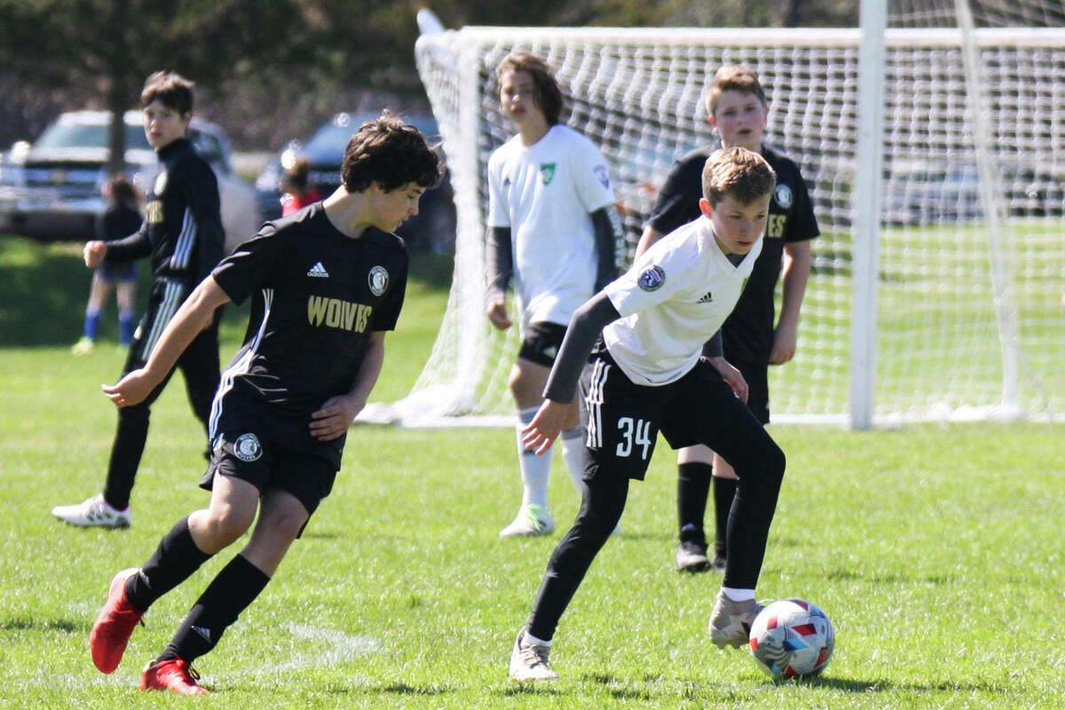 Midland Fusion's Wesley Post dribbles the ball while playing in the 39th annual Midland Invitational Tournament Saturday, May 9, 2022 at the Midland Soccer Club.