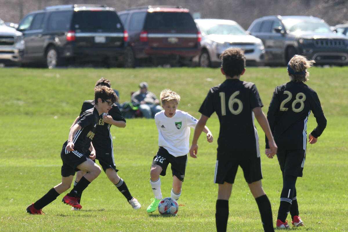 Midland Fusion's Owen McNames dribbles the ball while playing in the 39th annual Midland Invitational Tournament Saturday, May 9, 2022 at the Midland Soccer Club.