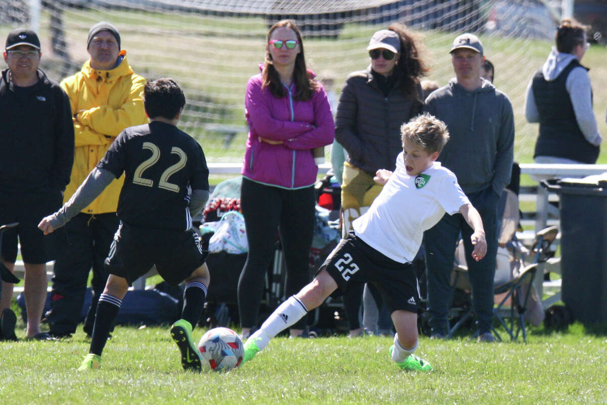 Midland Fusion's Owen McNames fights for the ball while playing in the 39th annual Midland Invitational Tournament Saturday, May 9, 2022 at the Midland Soccer Club.