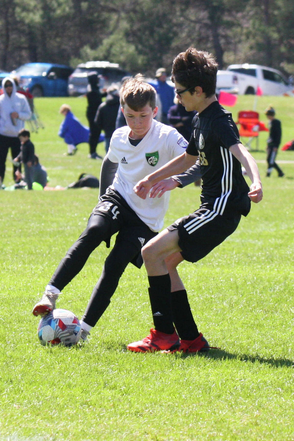Midland Fusion's Wesley Post dribbles the ball while playing in the 39th annual Midland Invitational Tournament Saturday, May 9, 2022 at the Midland Soccer Club.