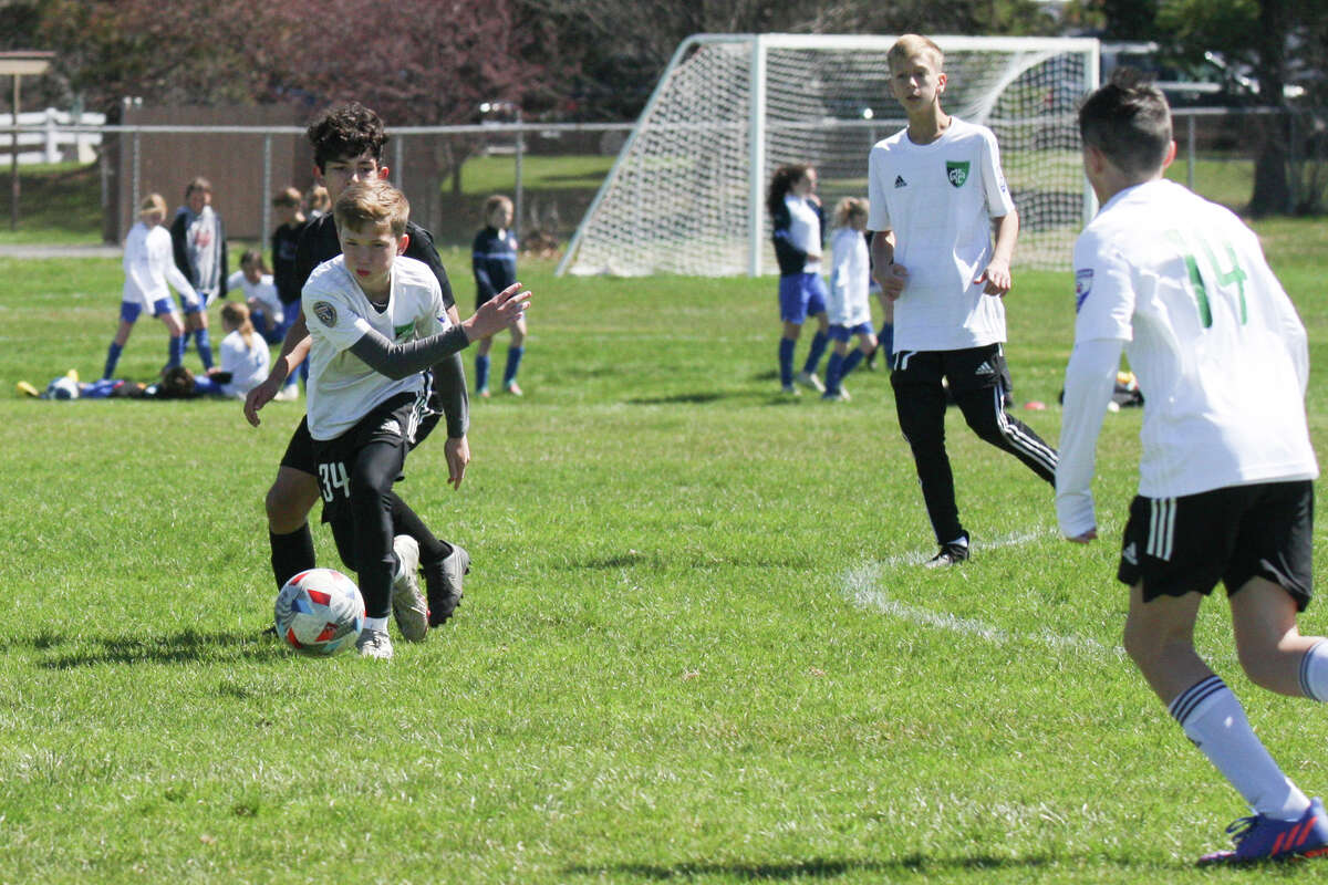 Midland Fusion's Wesley Post dribbles the ball while playing in the 39th annual Midland Invitational Tournament Saturday, May 9, 2022 at the Midland Soccer Club.