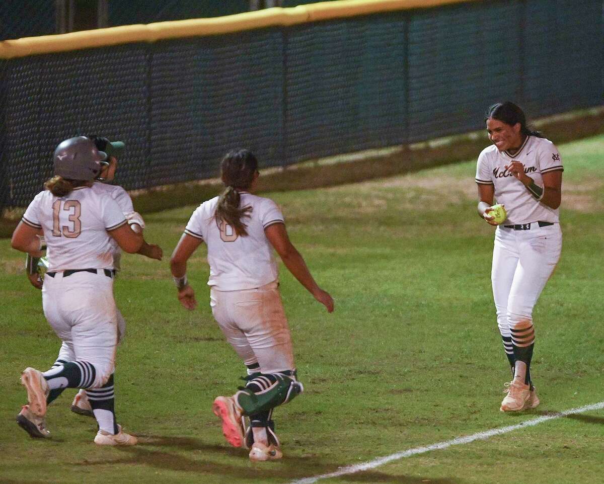 Rosalyn Rodriguez is chased by her McCollum teammates after she retrieved her game-winning home run ball after the Class 5A softball area playoff game at Northside Field on Friday, May 6, 2022. McCollum defeated Boerne Champion 5-2 in 11 innings.