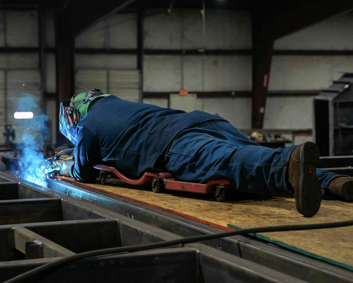 A person welding bunker components.