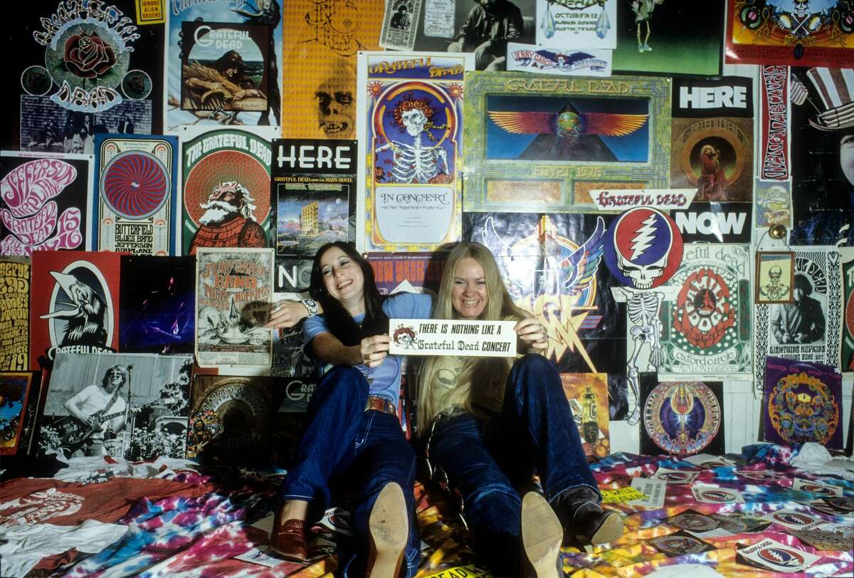 Deadheads pose in front of Grateful Dead posters at a Haight-Ashbury apartment in January 1980 in San Francisco.