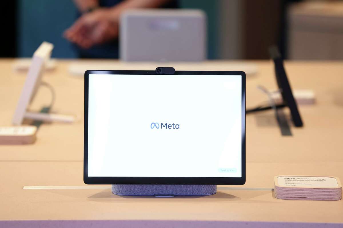 The Meta logo is displayed on a screen during a media preview of the new Meta Store on May 4 in Burlingame.