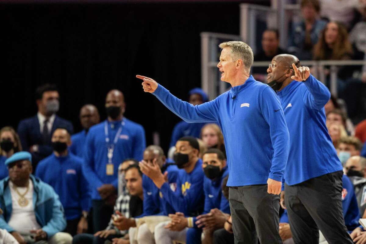 Golden State Warriors Head Coach Steve Kerr and Assistant Coach Mike Brown are seen on the sideline during the third quarter of their NBA basketball game against Chicago Bulls in San Francisco, Calif. Friday, Nov. 12, 2021.
