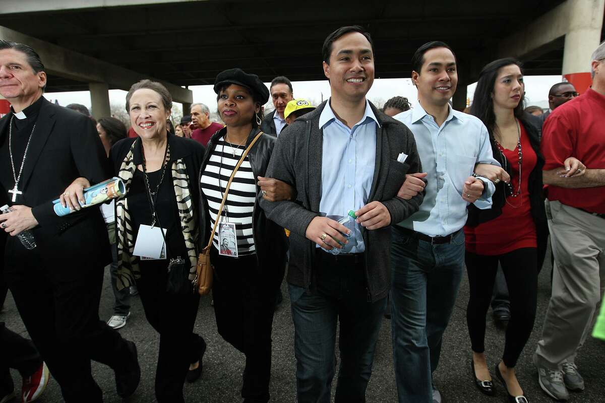 File - From left, Archbishop Gustavo Garcia-Siller, Aaronetta Hamilton Pierce, District 2 Councilwoman Ivy Taylor, Texas State Rep. Joaquin Castro, Mayor Julian Castro and his wife, Erica, participate in the city of San Antonio Martin Luther King Jr. 25th anniversary Commemorative March on Monday, Jan. 16, 2012. This year's theme was