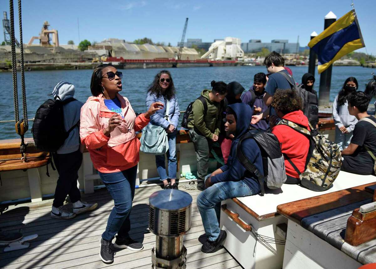 Discover Amistad educator Reeshemah Nofleet tells students the history of the Amistad uprising aboard a reproduction of the ship docked at Harbor Point in Stamford, Conn. Monday, May 9, 2022. Eighth grade students toured the ship to kick off the new partnership between Stamford Public Schools and Discovering Amistad. Students learned about the 1839 Amistad slave rebellion and the subsequent Supreme Court decision to free the rebels.