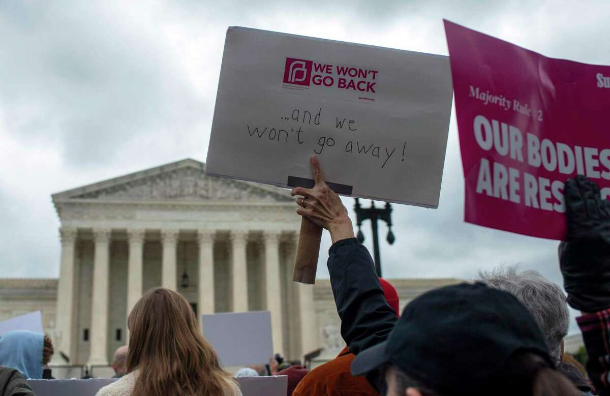 Abortion rights activists hold signs during a Mothers Day demonstration outside the U.S. Supreme Court in Washington, D.C.