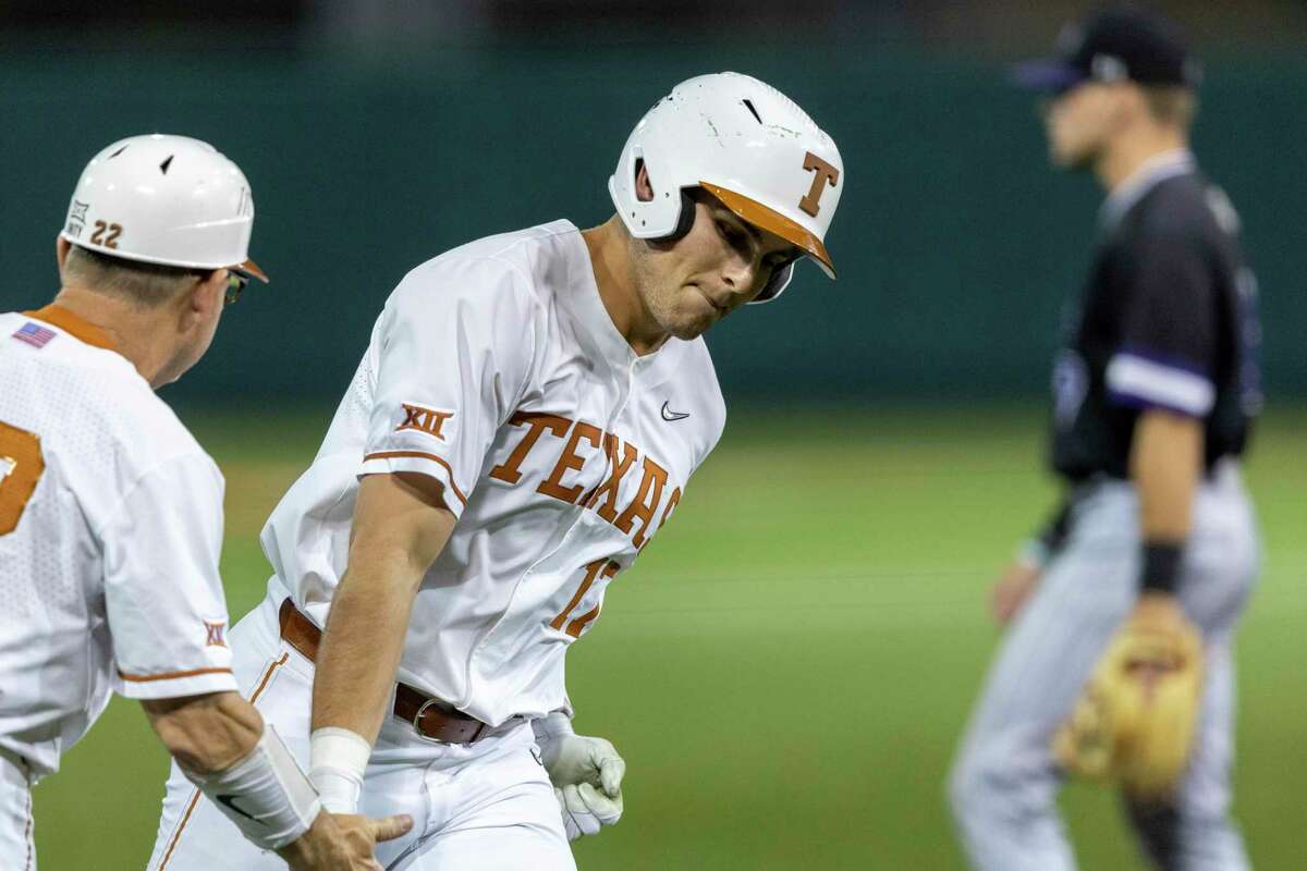 Texas first baseman Ivan Melendez celebrates scoring his second home run of the night against Stephen F. Austin with head coach David Pierce during an NCAA baseball game on Tuesday, April 12, 2022, in Austin/