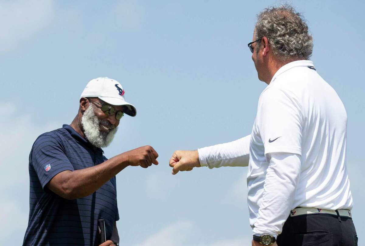 Texans coach Lovie Smith, left, hopes Monday’s fist bump with team CEO Cal McNair, which occurred at the team’s 19th annual charity golf classic, is a precursor of many to come in 2022.