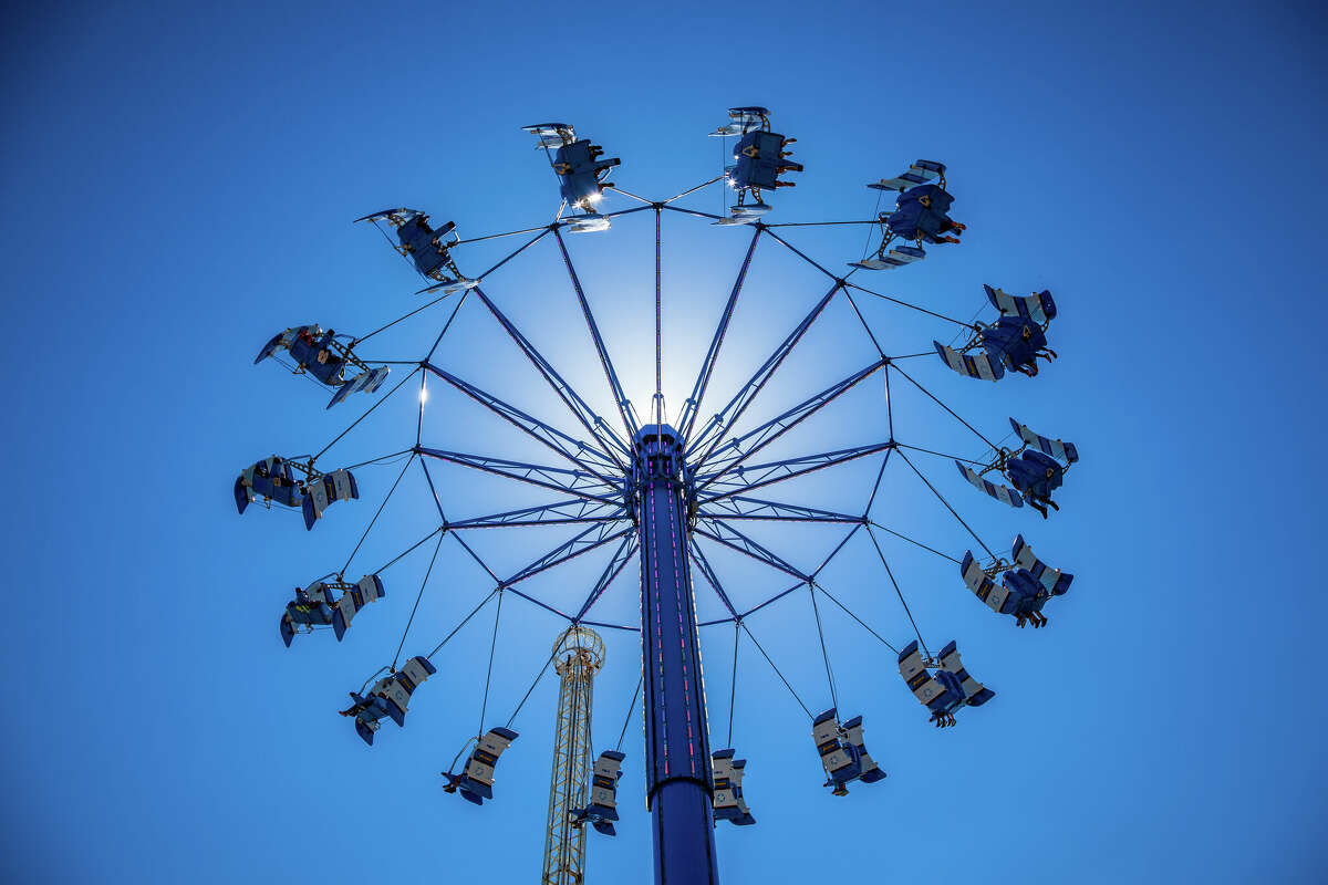 Riders enjoy the Aviator swing ride at Kemah Boardwalk near Houston, Texas. The ride takes you high above the waters of the Gulf of Mexico.