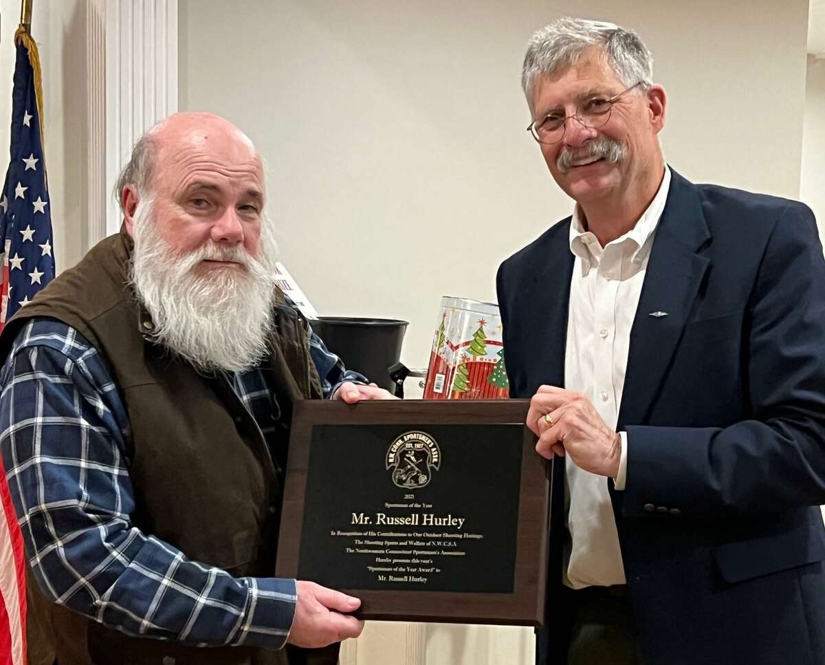 Russel Hurley, left, receives presentation by Tom Andersen, President of The Northwestern CT Sportsmen’s Association with the Peter Holms Trophy for Sportsman of the Year at the organization’s 95th annual banquet.