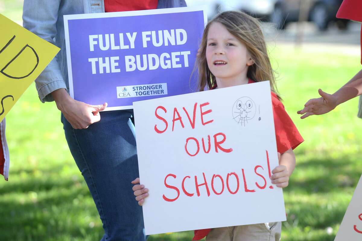 Abe Kimball, a kindergartner from Lordship Elementary School, takes part in a rally outside of Town Hall, in Stratford, Conn. May 9, 2022. Teachers, parents and students gathered prior to Monday evening’s Town Council meeting to vocalize their concerns about the town’s budget plans, which they say could result in staffing layoffs or school closures.