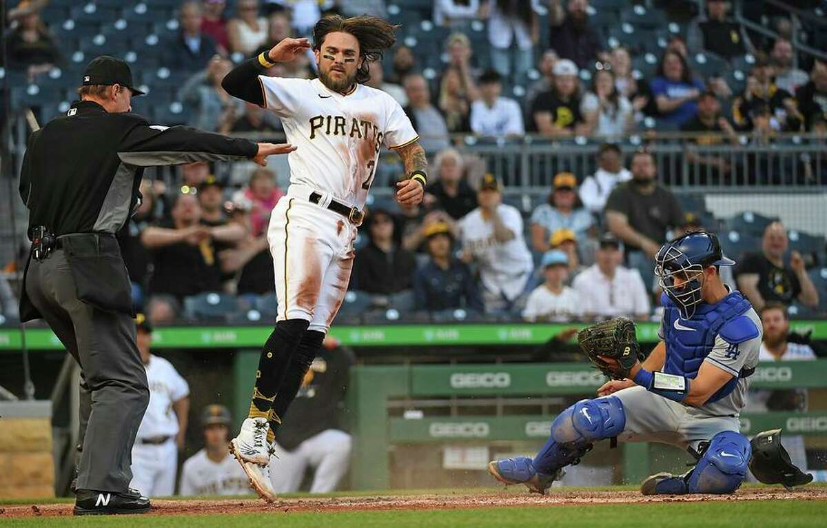 Michael Chavis of the Pirates scores past Dodgers catcher Austin Barnes in the fourth inning in Pittsburgh.