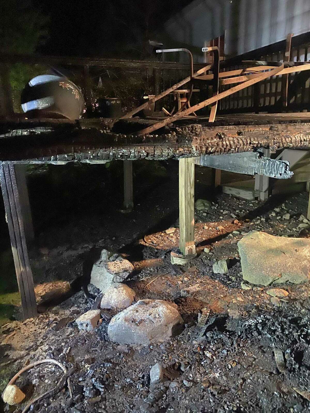 The remains of a deck at a home on Hunting Lane that caught fire in Westport, Conn. on May 10, 2022.