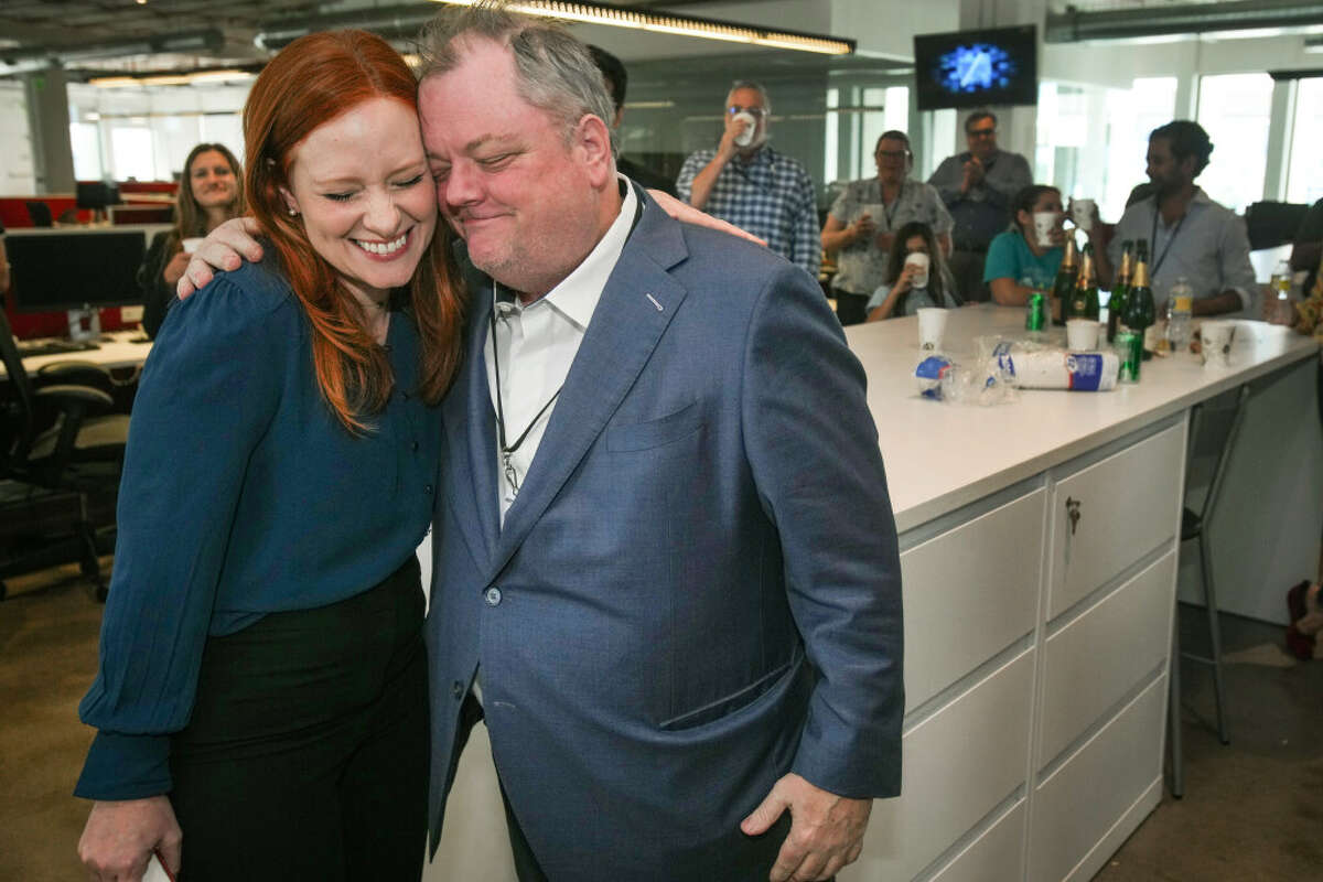 Lisa Falkenberg, editor of opinion for the Houston Chronicle, left, and Michael Lindenberger, deputy opinion editor, embrace as they celebrate winning a Pulitzer Prize for editorial writing Monday, May 9, 2022 in Houston. The Chronicle Editorial Board, Falkenberg, Lindenberger, Joe Holley and Luis Carrasco, on Monday won a 2022 Pulitzer Prize in editorial writing for a series on voter suppression in Texas. Under a banner called "The Big Lie," the multi-part series examined and debunked decades-long, Republican-driven falsehoods about voter fraud.
