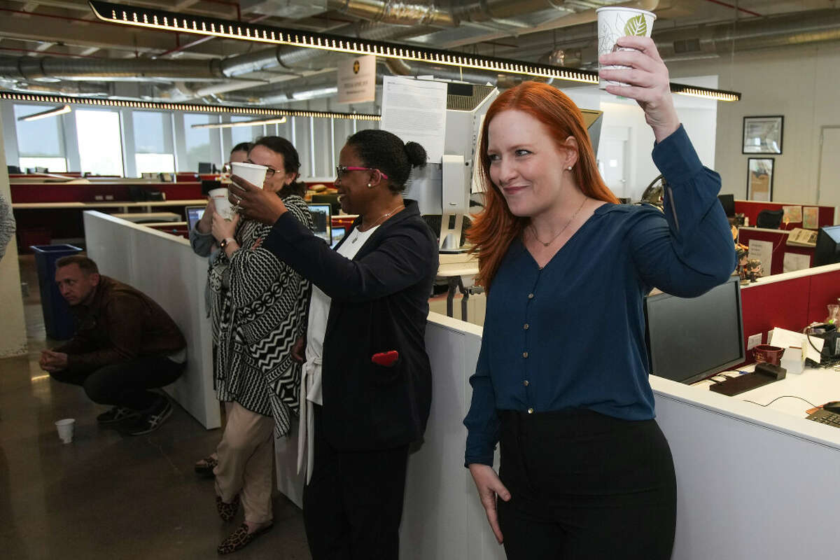 Lisa Falkenberg, editor of opinion for the Houston Chronicle, raises a cup to celebrate winning a Pulitzer Prize for editorial writing Monday, May 9, 2022 in Houston. The Chronicle Editorial Board, Falkenberg, Michael Lindenberger, Joe Holley and Luis Carrasco, on Monday won a 2022 Pulitzer Prize in editorial writing for a series on voter suppression in Texas. Under a banner called "The Big Lie," the multi-part series examined and debunked decades-long, Republican-driven falsehoods about voter fraud.