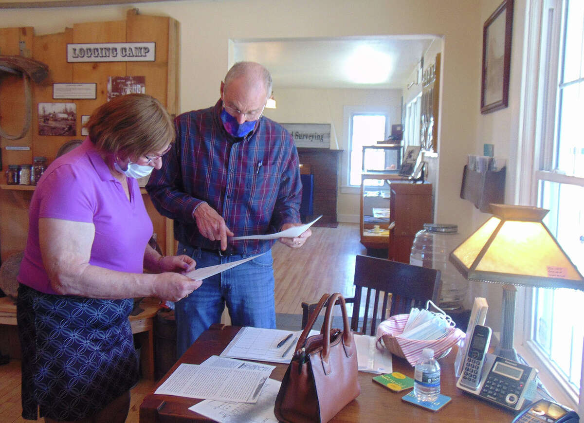 Lake County Historical Society President Bruce Micinski assists a woman from out of state researching her Lake County ancestors