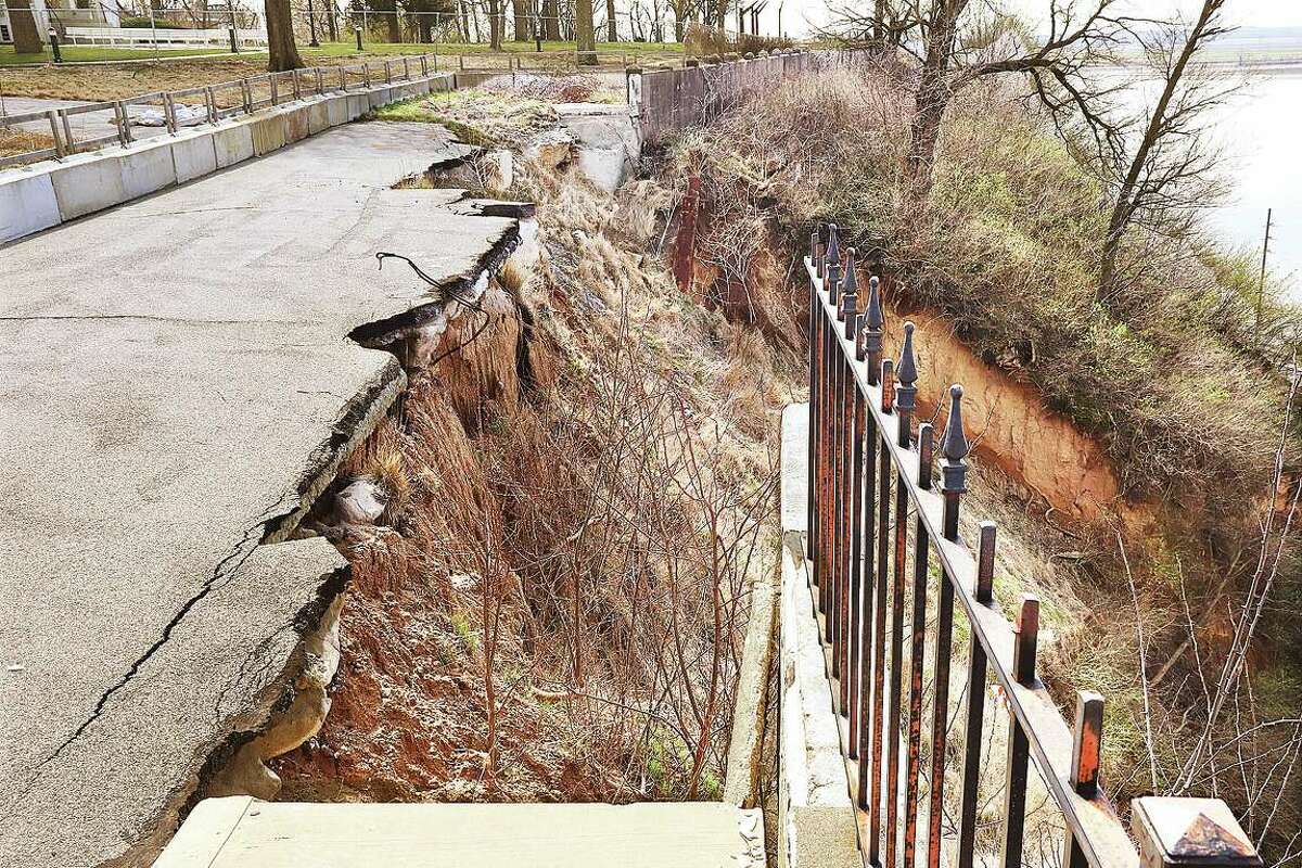 The section of Riverview Drive, next to Riverview Park, background, remains un-repaired following the bluff collapse and closure in August 2019. If plans are approved, plans, repairs could finally begin this August.