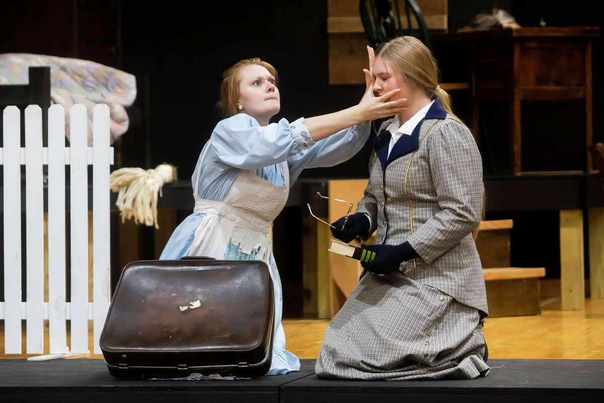 Alectra Bork as Helen Keller, left, and Kristen Warren as Annie Sullivan, right, act out a scene during a dress rehearsal for Calvary Baptist Academy's production of "The Miracle Worker" Friday, May 6, 2022 at the school in Midland.