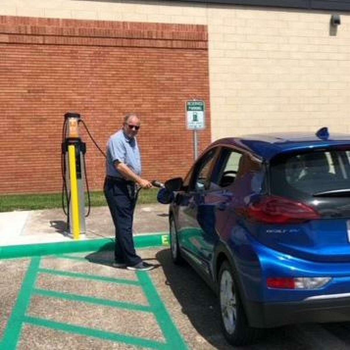 An electric vehicle charging station is available in front of the Lamar University Police Department building.