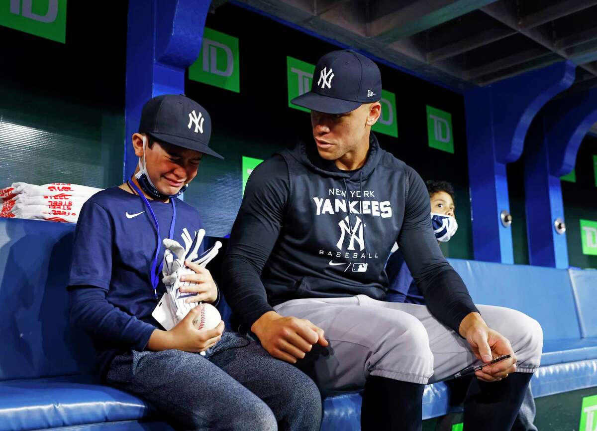 Fan Derek Rodriguez, 9, reacts while meeting Aaron Judge of the New York Yankees prior to a MLB game against the Toronto Blue Jays at Rogers Centre on May 4, 2022, in Toronto. A video of Rodriguez becoming emotional after receiving an Aaron Judge home-run ball from Toronto Blue Jays fan Mike Lanzillotta went viral on social media after Tuesday’s game.