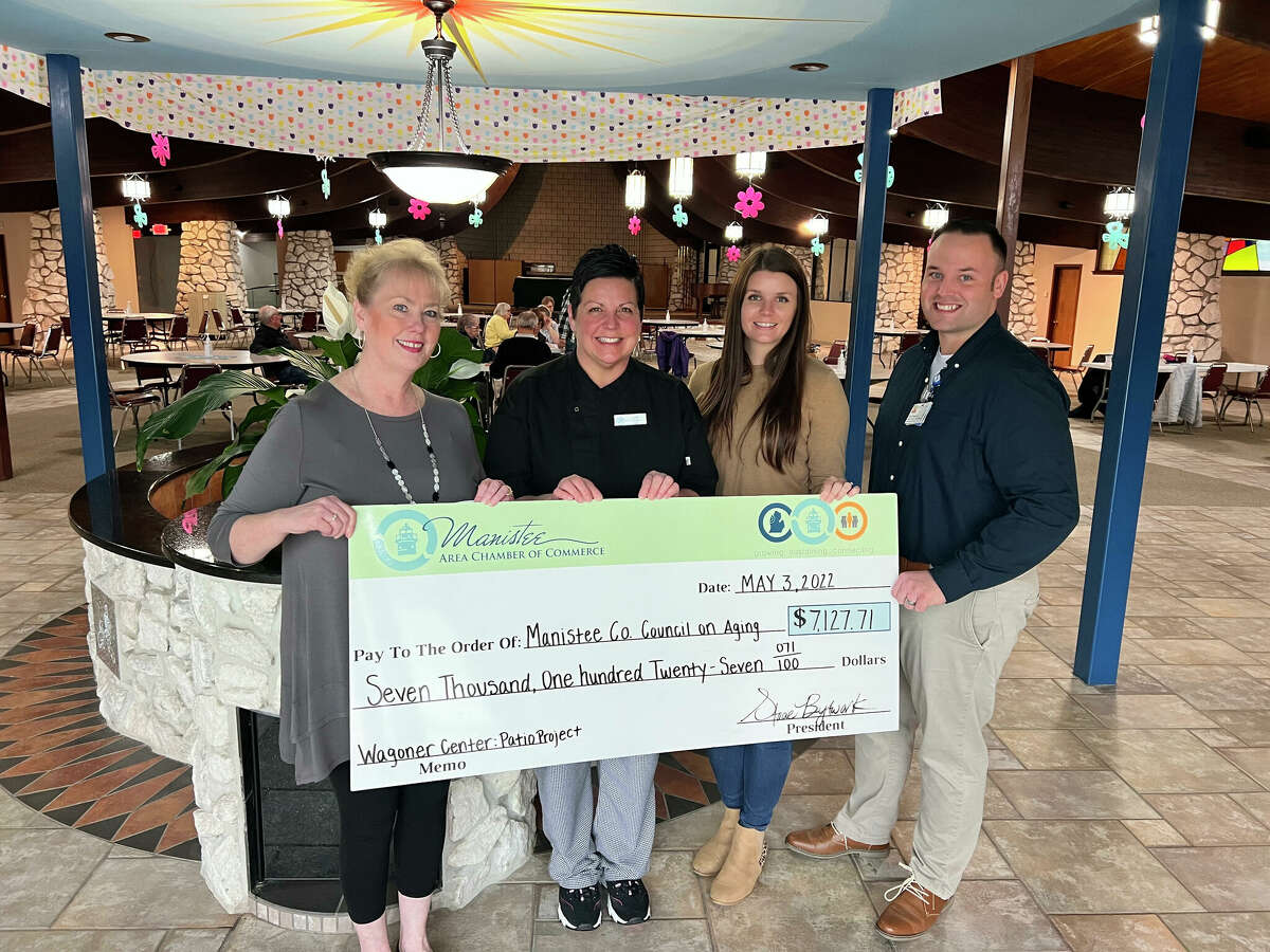 Members of the Manistee area Chamber of Commerce Leadership Program awards a $7,127.71 check to Sarah Howard (left) executive director of the Manistee County Council on Aging to help fund a patio project at the council's Wagoner Community Center. 
